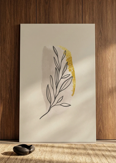 Akustikbillede med et gult blad med tegnede konturer, i nærbillede lænet mod væggen med små dekorationssten