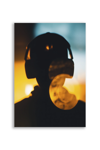 Akustikbillede med en silhuet med hovedtelefoner i gyldent lys